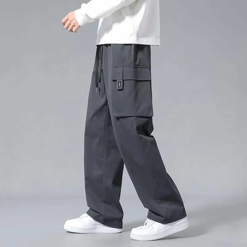 Boy's straight-leg cargo trousers in Army Green with drawstring waist and large side pockets.
