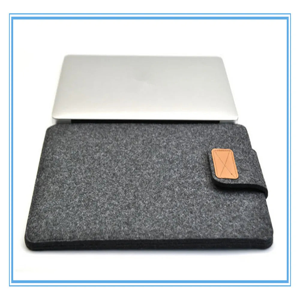 Clamshell laptop bag in dark grey with woven texture, shown open to reveal plush interior lining.