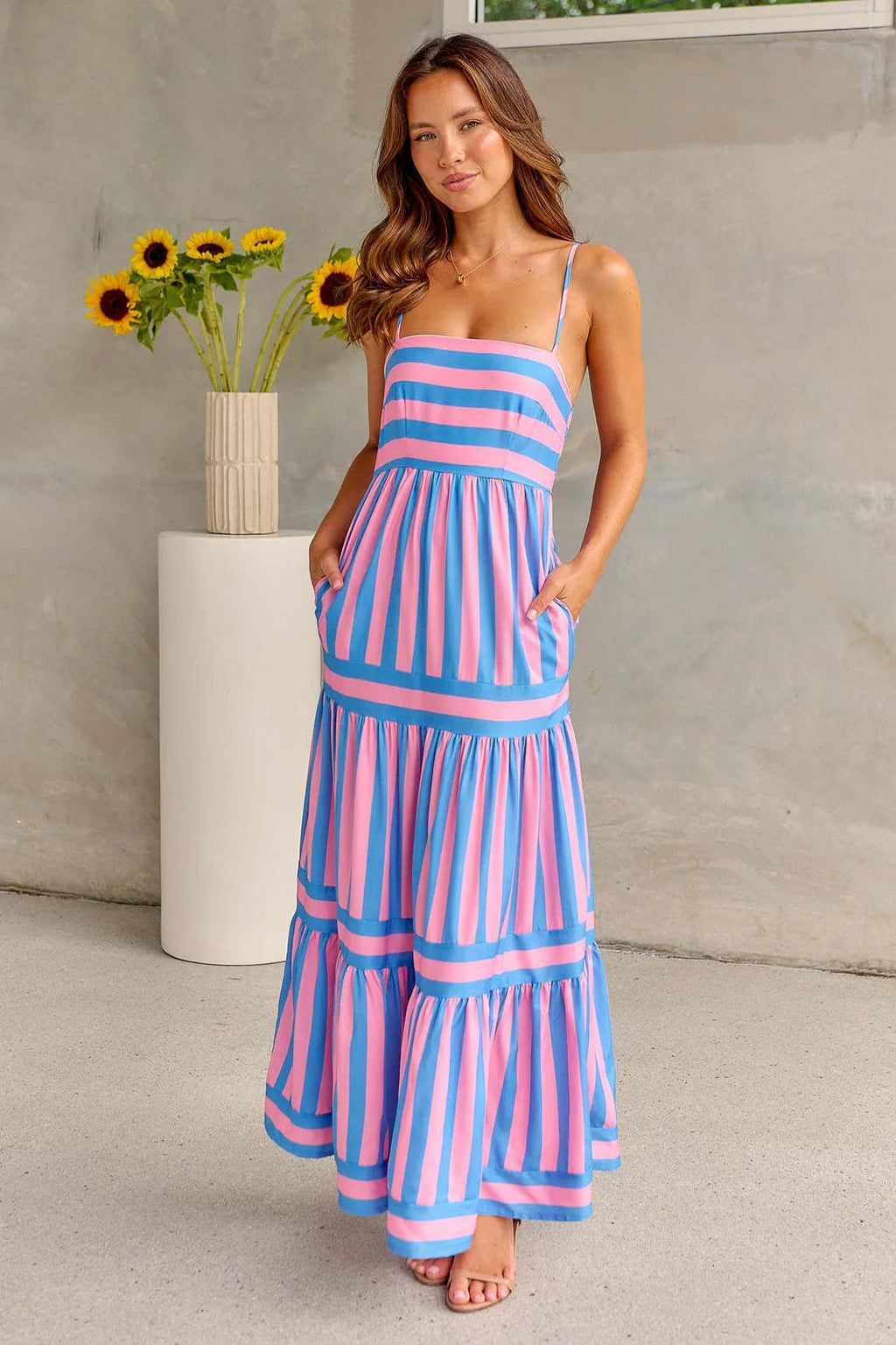 Women's striped printed suspender long dress with square neck, backless design, and side pockets.