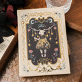 A5 retro Gothic art notebook with thematic cover, shown next to pen for scale