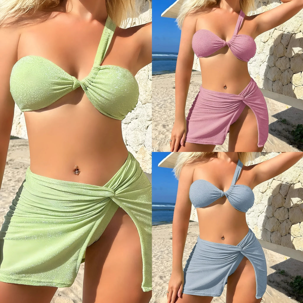 Women's one-shoulder glossy polyester swimsuit set in light green, including top, pants, and skirt.