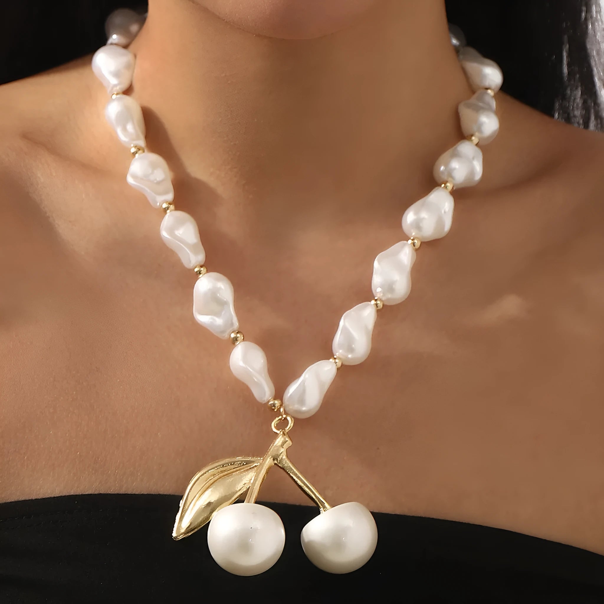Women's adjustable pearl chain necklace with a geometric cherry fruit alloy pendant in gold colour.