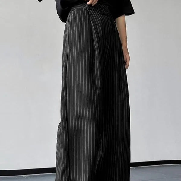 Man wearing black vertical stripe pleated casual trousers.