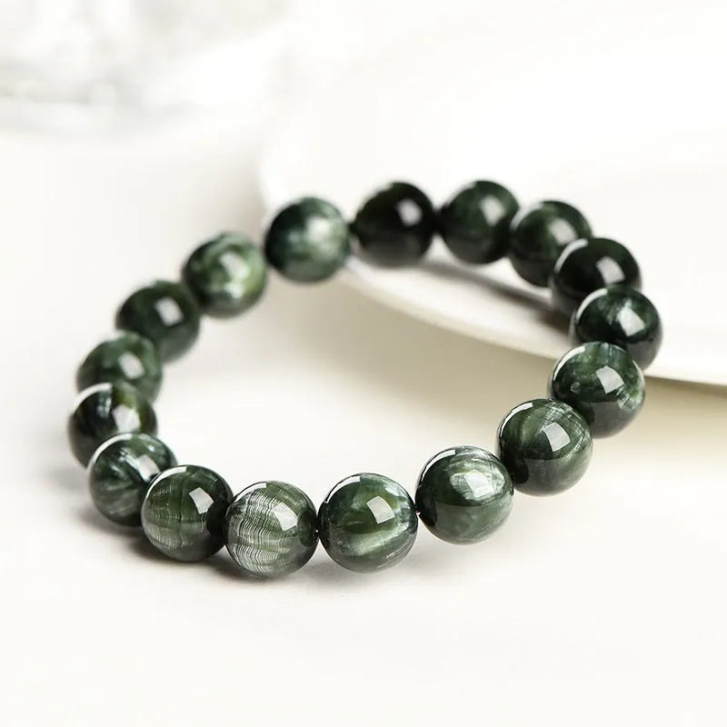 Green Dragon Crystal bracelet with round 8-9mm beads on a wrist.