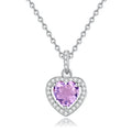 Heart-shaped sterling silver necklace with a round amethyst gemstone on a cross chain.