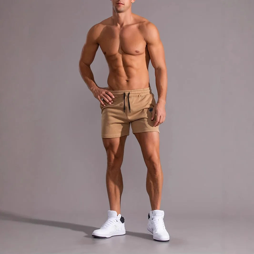 Men's khaki sports shorts with coconut palm leaf print, elastic waistband, straight cut design