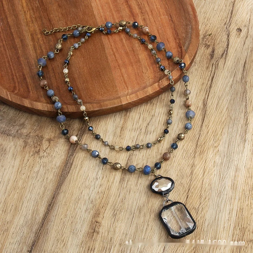 Tribal style necklace with two-layer pendant featuring natural stone and glass elements on chain