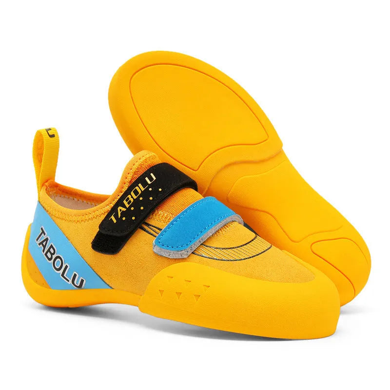 Beginner rock climbing shoes with Velcro strap and wear-resistant rubber sole in black and red colour.