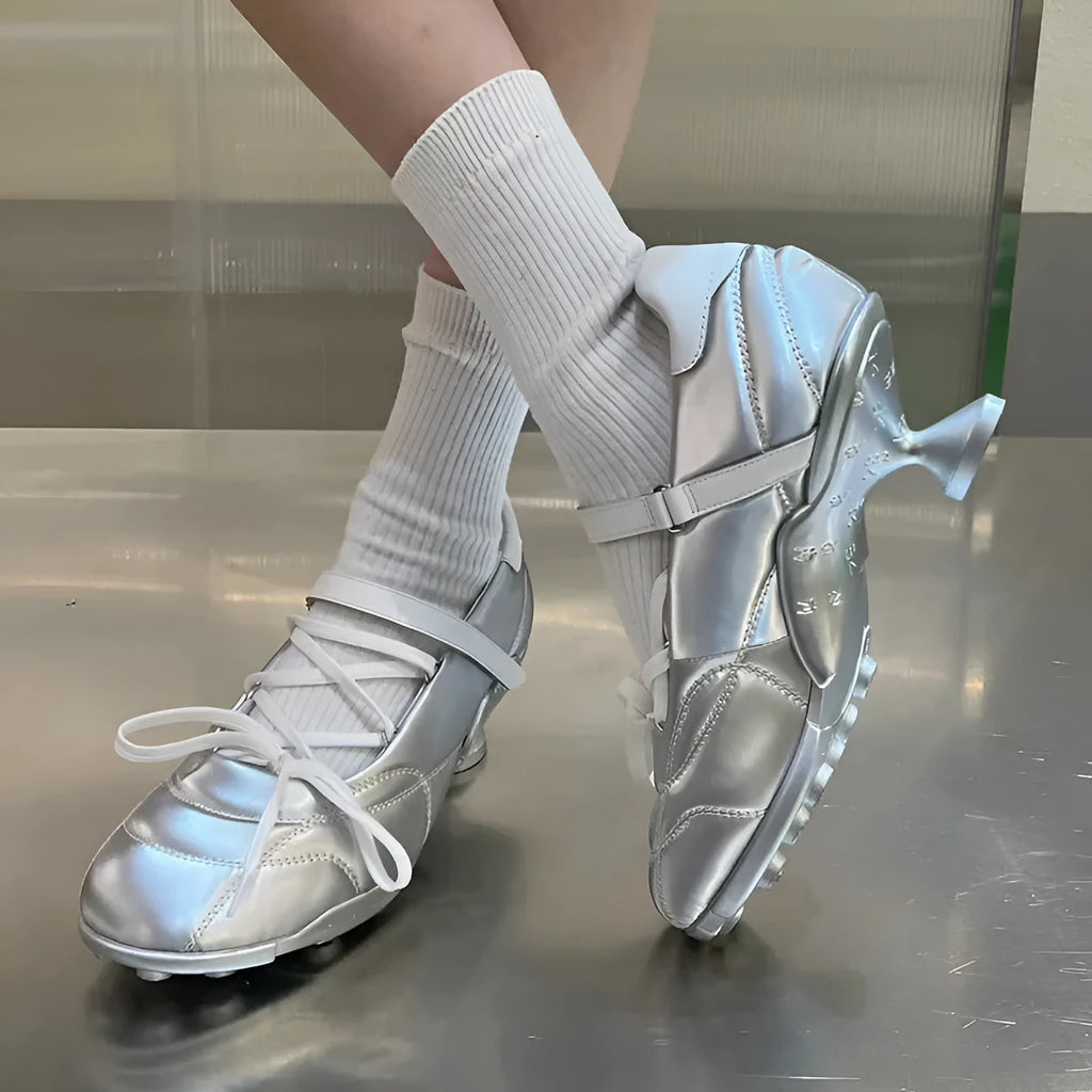 Women's silver lace-up bow sports shoes with a round toe and mid heel on a white background.