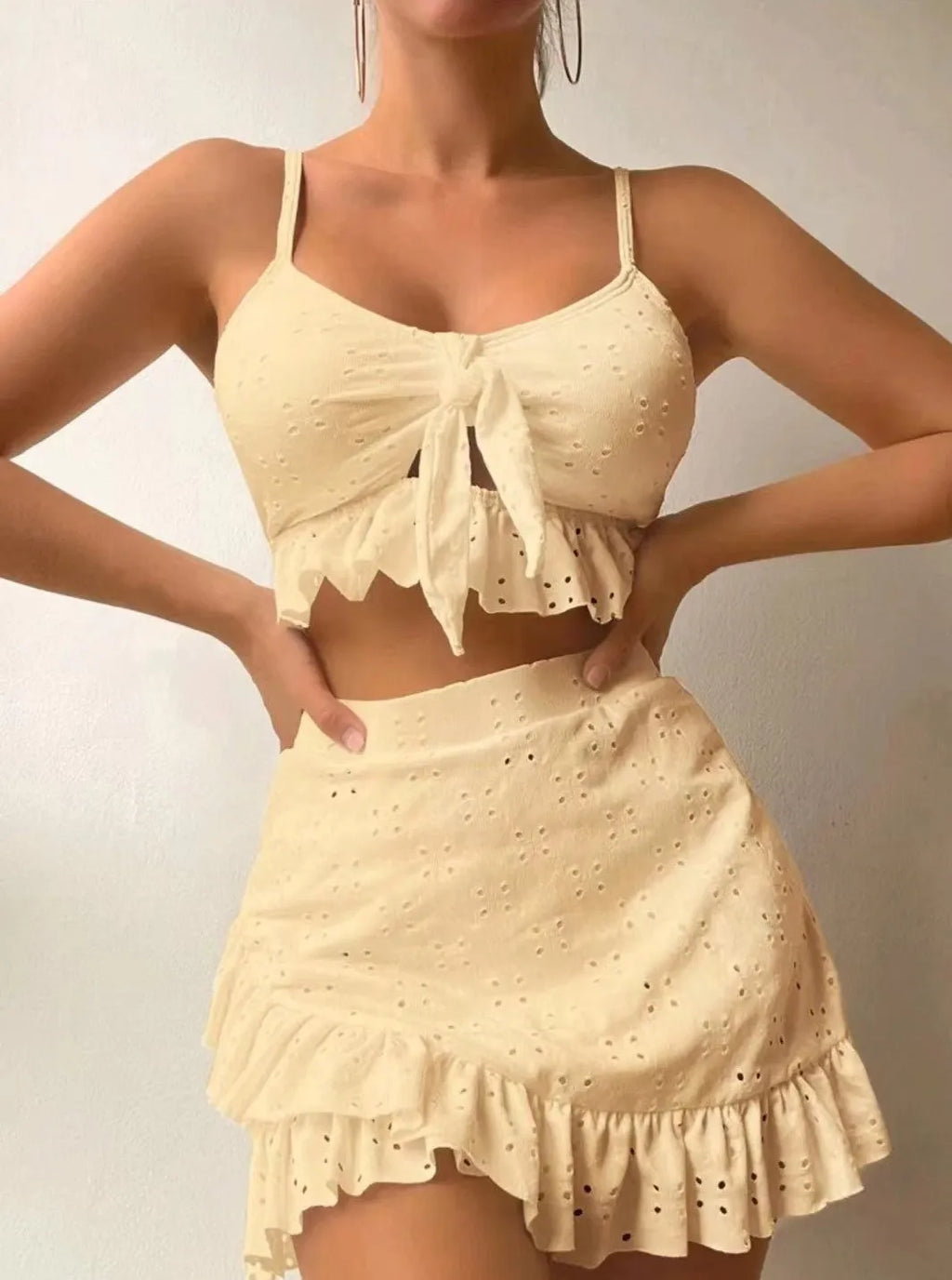 Women's solid colour three-piece swimsuit with bikini top, bottoms, and split hip skirt.