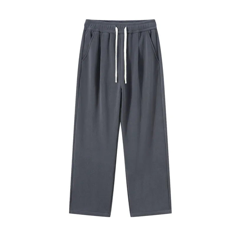 Men's double-sided polar fleece winter sports trousers in apricot colour, showing loose fit and drawstring waistband.