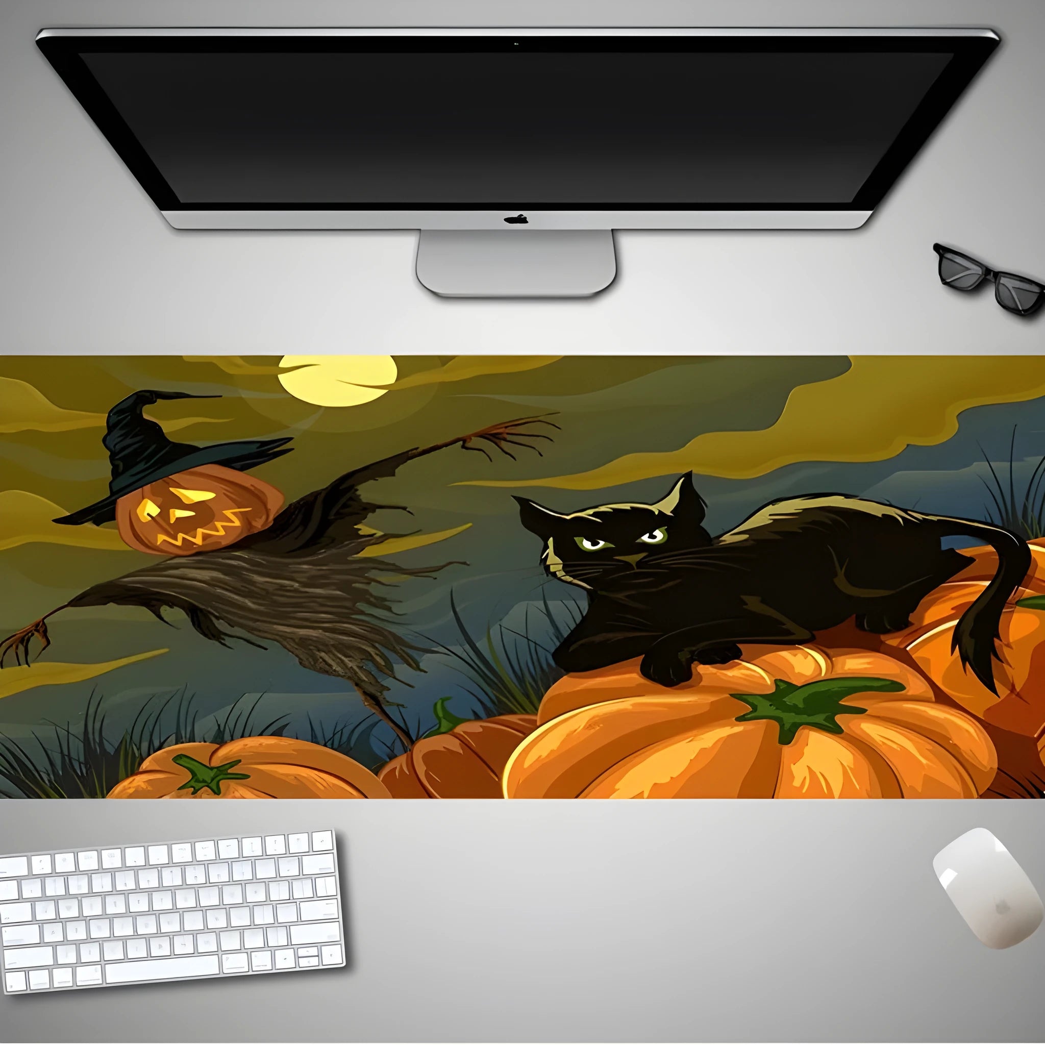 Oversized rectangular Halloween-themed mouse pad on a desk, showing non-slip rubber cloth base.