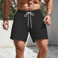 Men's solid colour casual track shorts in a loose straight-leg style on a white background.
