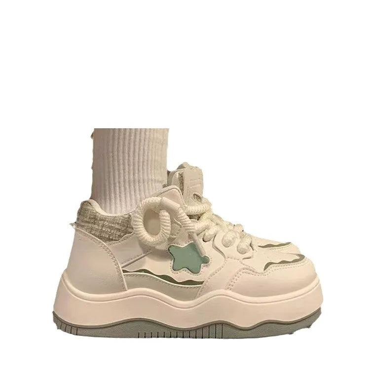 Women's green patent leather platform sneakers with round toe and lace-up front