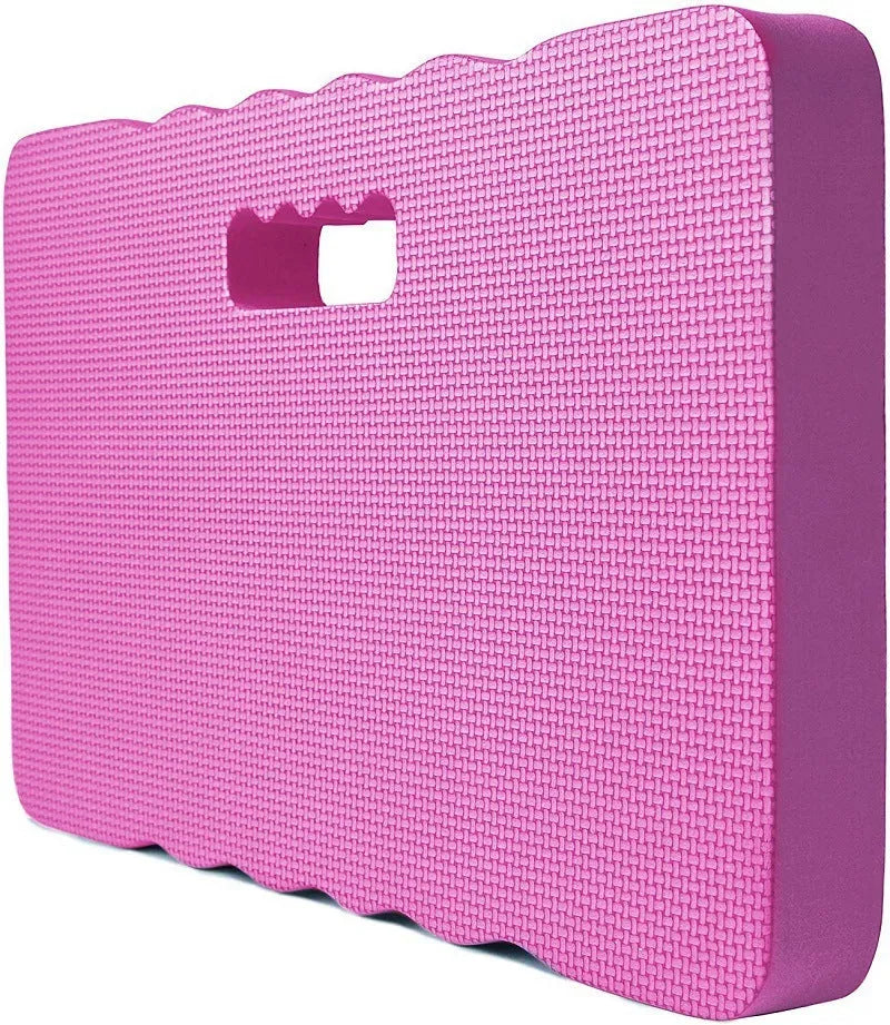 Solid blue EVA foam garden kneeler pad on soil for comfortable planting and weeding.