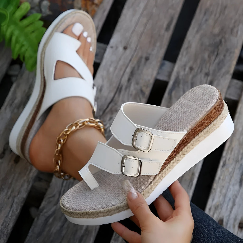 White patent leather wedge sandals with woven upper and finger-fit toe separation design
