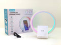 White circular smart Bluetooth speaker with ambient lighting and wireless charging pad
