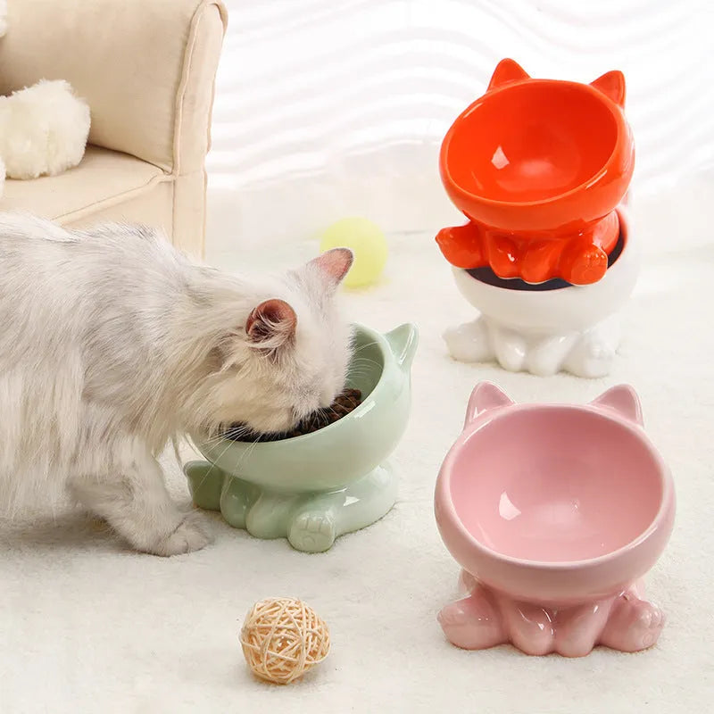 Ceramic cat bowl in black and white with oblique mouth shape on a light background