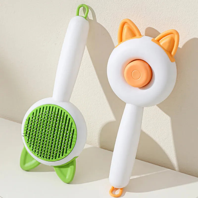 Circular greenish white pet grooming brush with stainless steel teeth and rubber massage nodules.