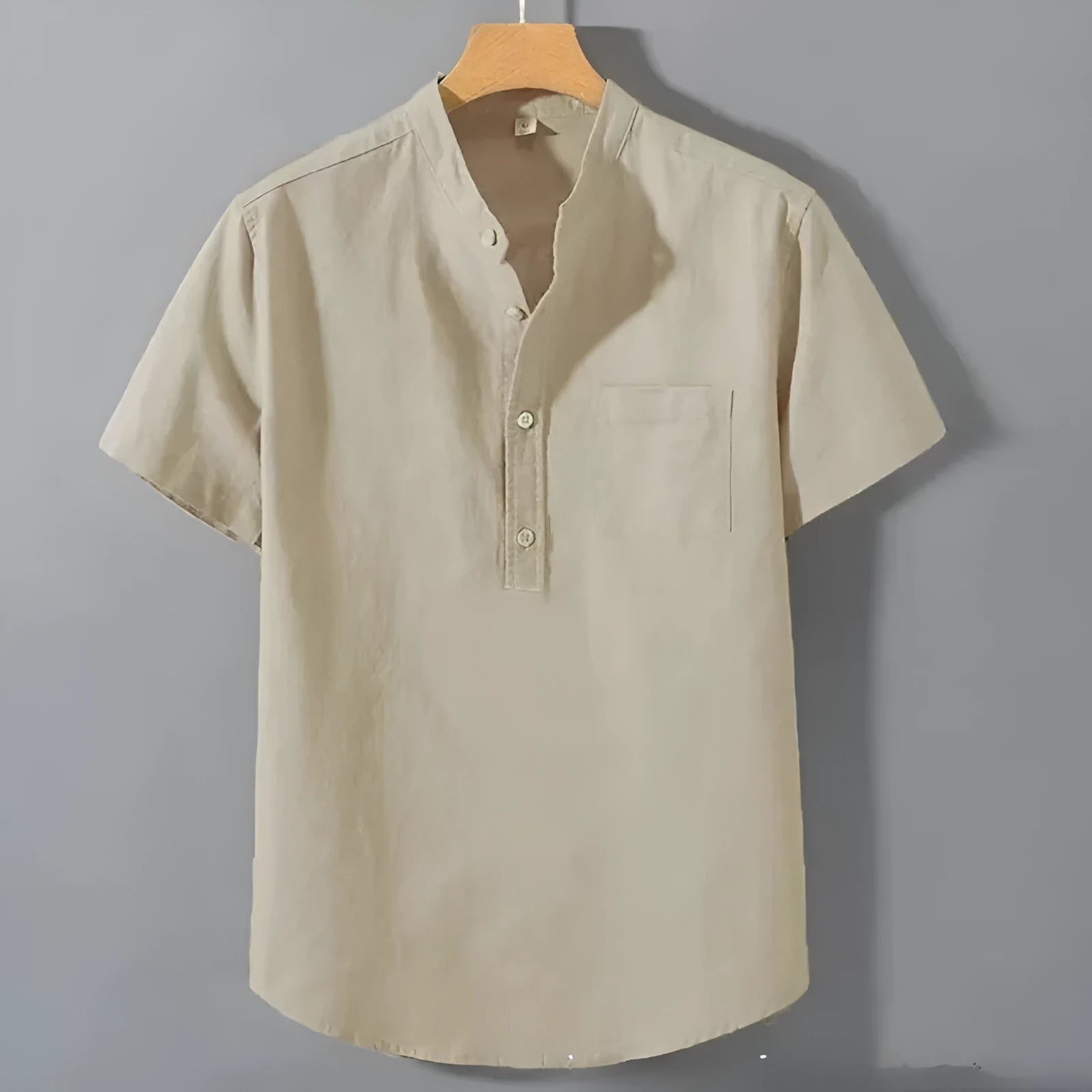 Men's loose-fit solid colour linen shirt with a stand collar and short sleeves on a hanger.