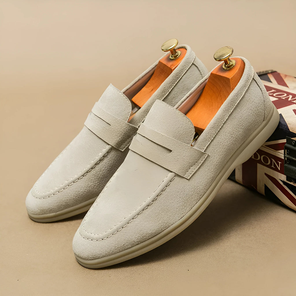 Men's black leather slip-on casual shoes with a round toe and mid-height heel on a rubber sole.