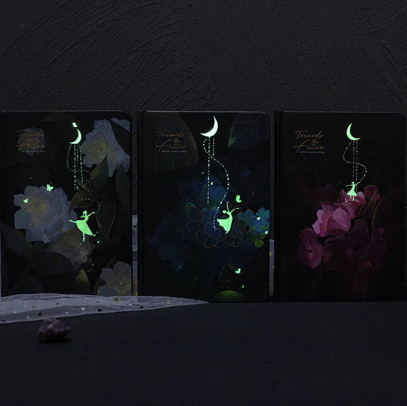 A5 notebook with luminous cover open to show pages filled with colour illustrations