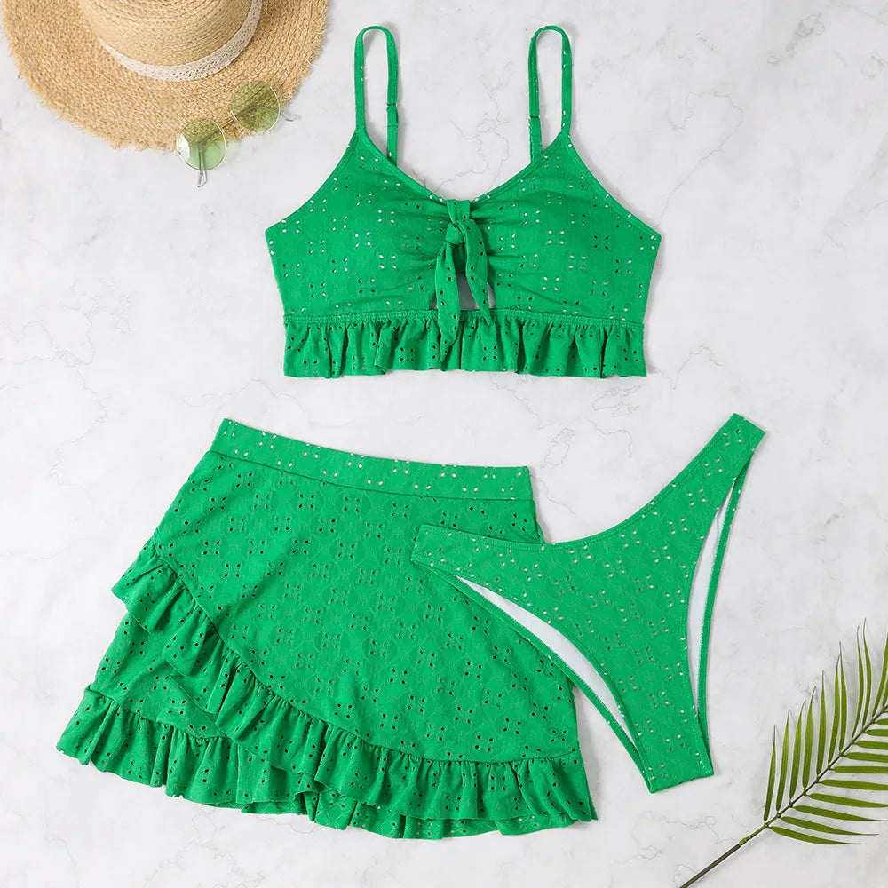 Women's solid colour three-piece swimsuit with bikini top, bottoms, and split hip skirt.