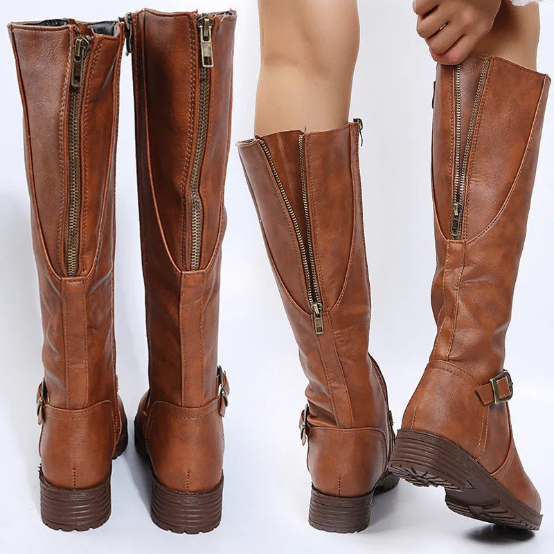Women's knee-high knight boots in black with a square heel and a silver belt buckle detail on the side.