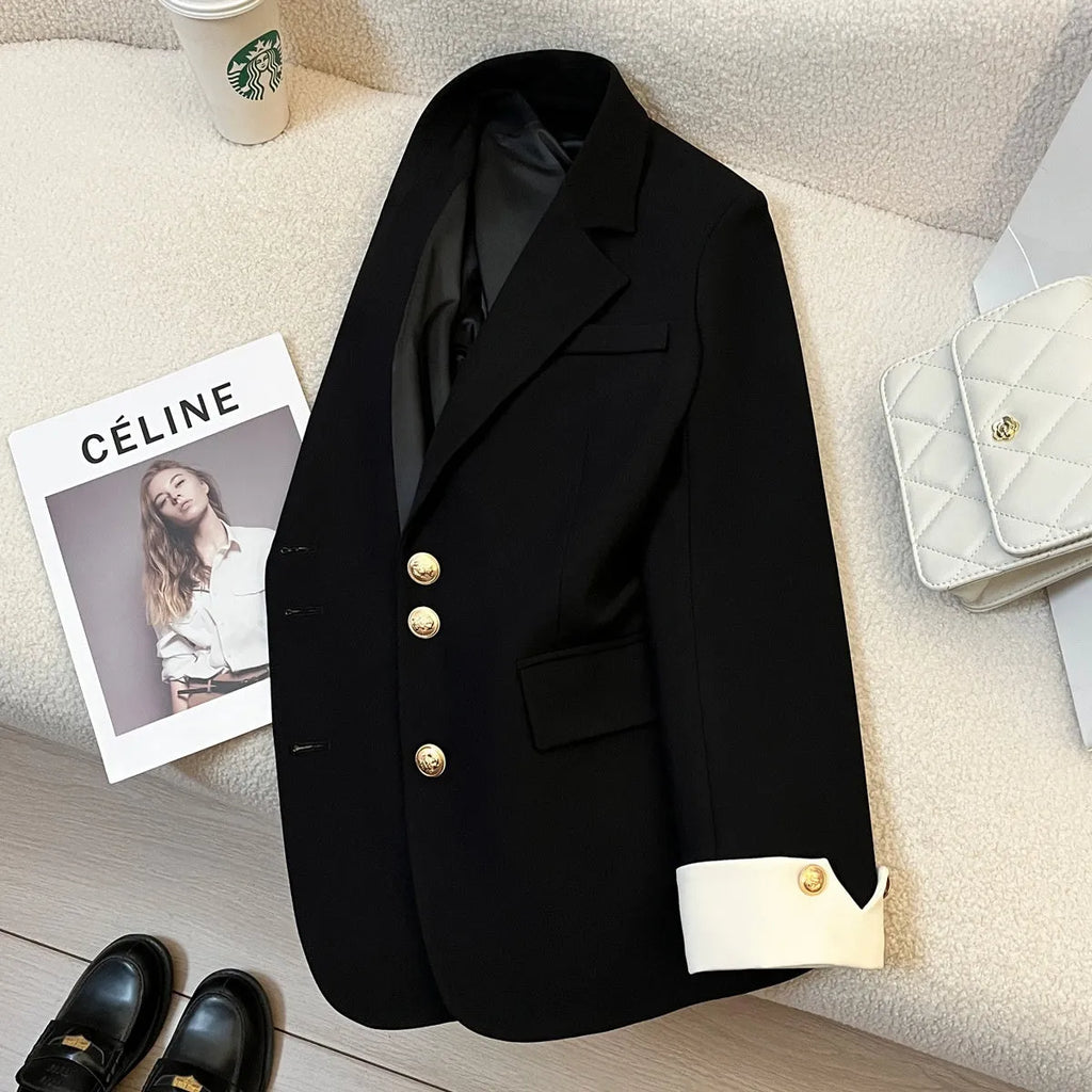 Milky white loose-fit women's trench coat with long sleeves and pockets on a hanger.
