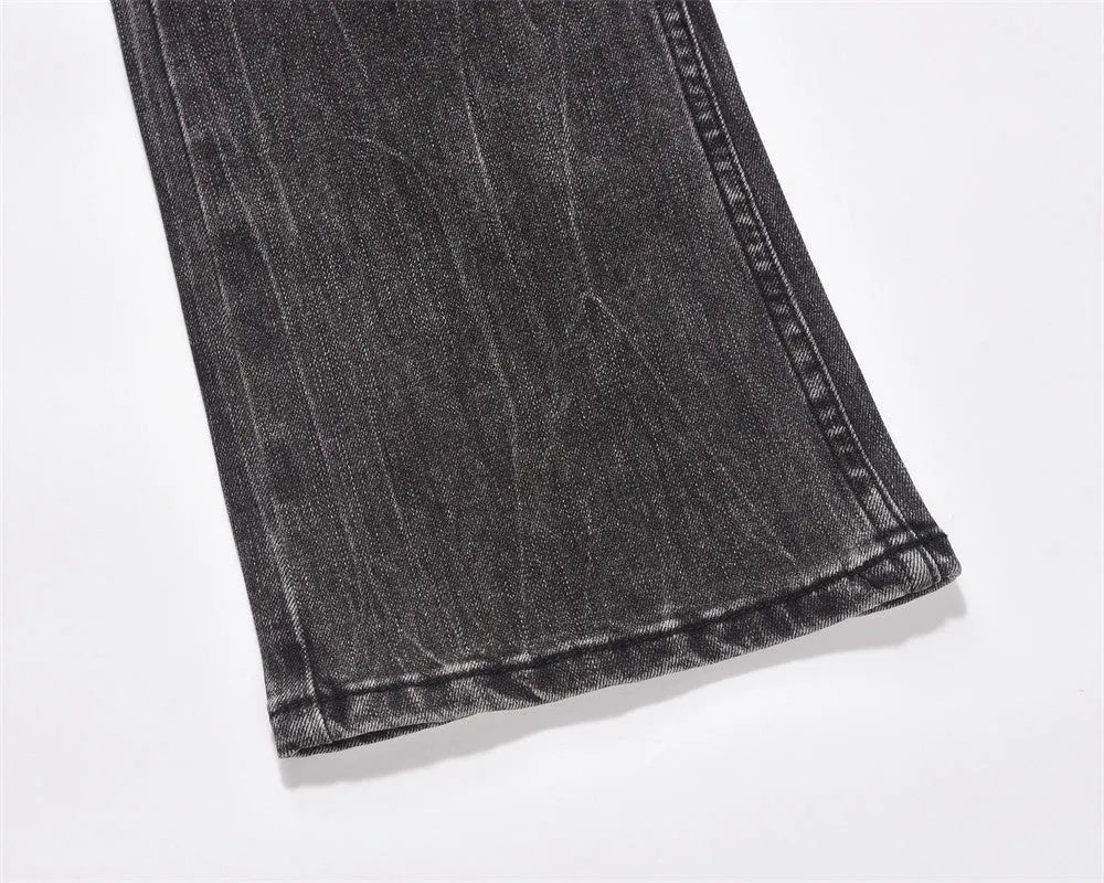Men's black washed wear-white denim jeans on a plain background showing front view
