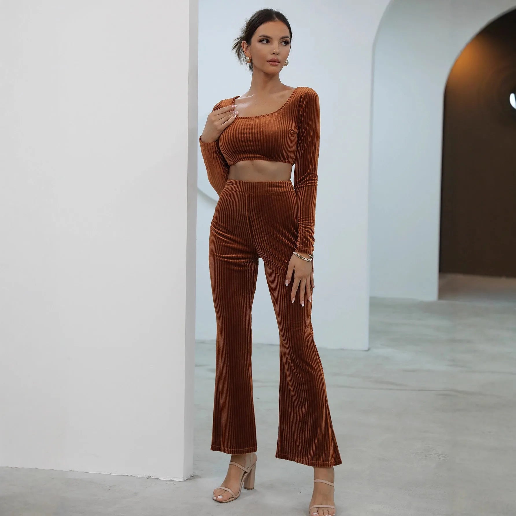 Caramel coloured long sleeve sweater and trouser casual set laid flat.