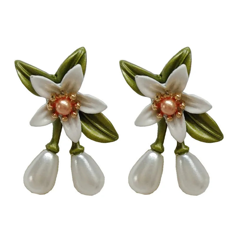 Women's alloy earrings set showing flower studs and camellia ear clip in contrasting colours