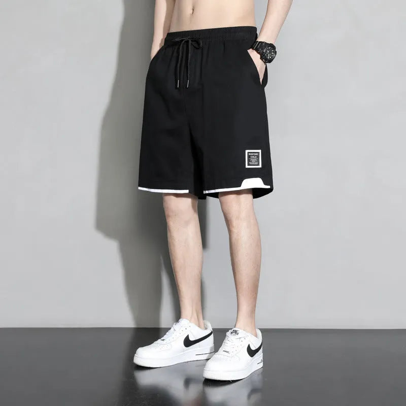Boys' black cotton shorts in a plus size on a hanger