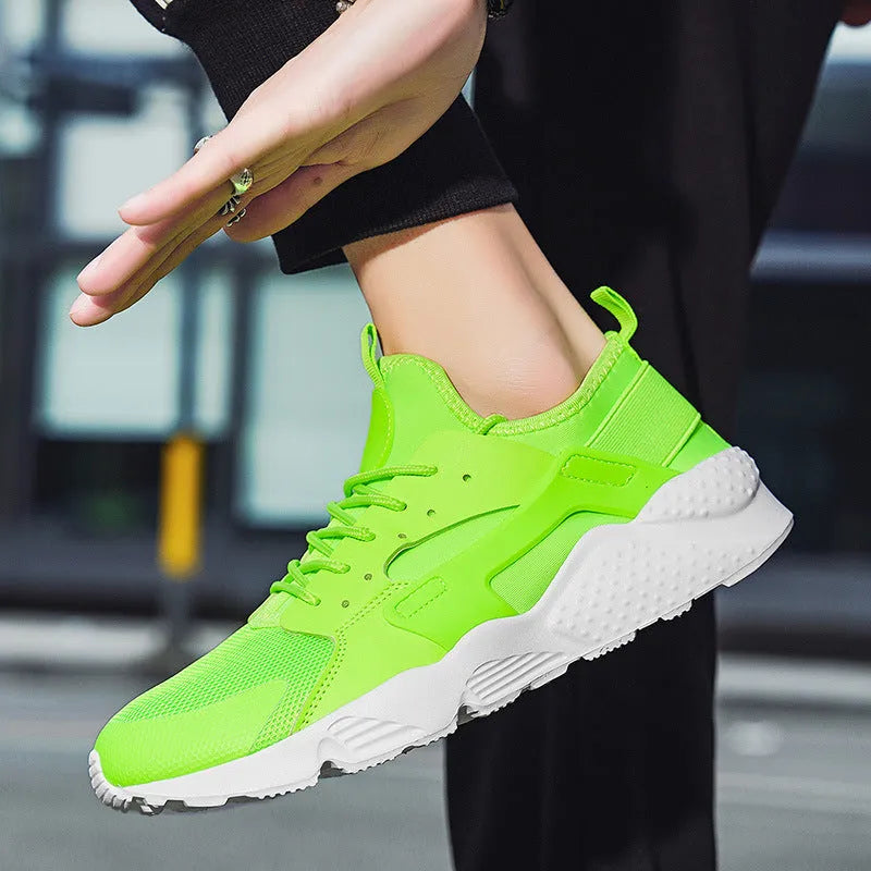 Men's green low top casual mesh shoes with cross shoulder straps and flat sole.