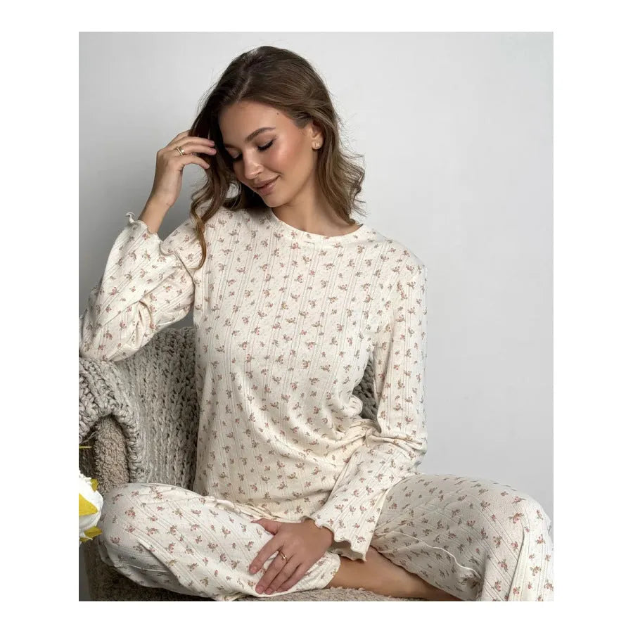 White women's floral print polyester two-piece suit with bell sleeve top and wide-leg trousers.