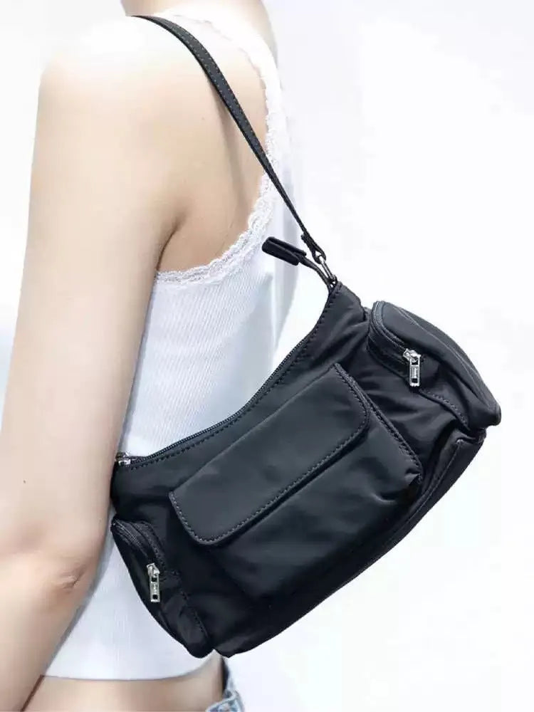 Black PU women's shoulder bag with double pockets showing side line detail, 24cm length