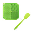 Blue silicone dog licking mat with textured surface and suction cups on a kitchen floor.