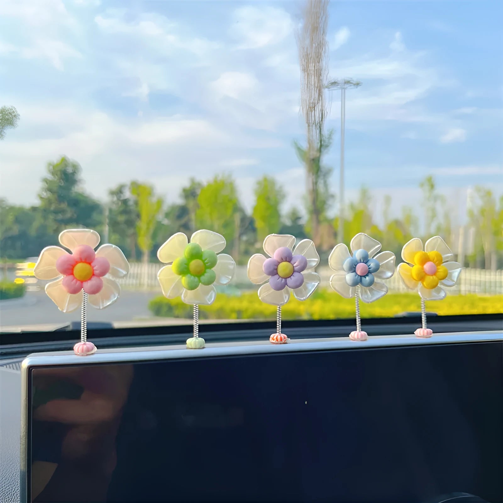 Small colourful plastic car swing decoration for dashboard or mirror.