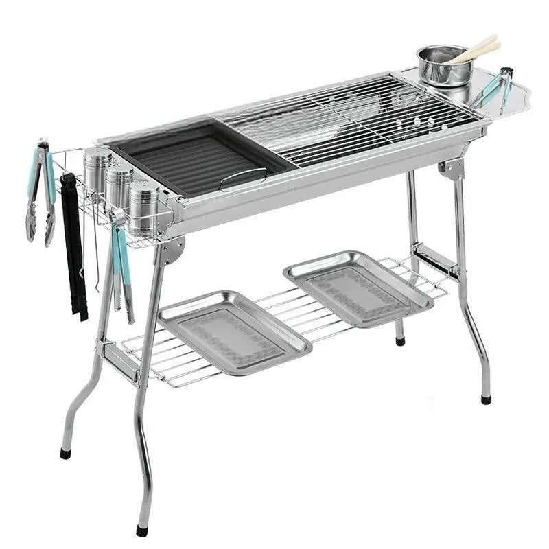 Stainless steel portable folding barbecue oven with grilling surface, shown in natural metal finish.