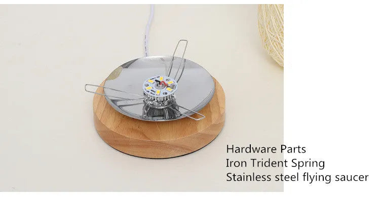 Sepak Takraw ball design desk lamp made of brown hemp rope and wood with a warm LED light.
