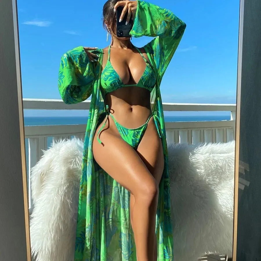 Women's floral pattern bikini set with long sleeve cover-up and banded briefs on a mannequin
