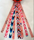 Close-up of a coloured ribbon streamer attached to a child's bicycle helmet.