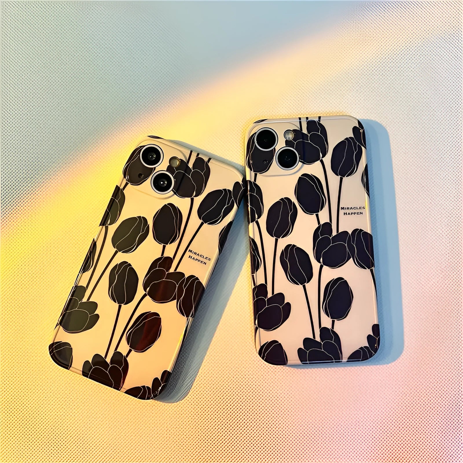 Black silicone iPhone case with a tulip flower design on the back.