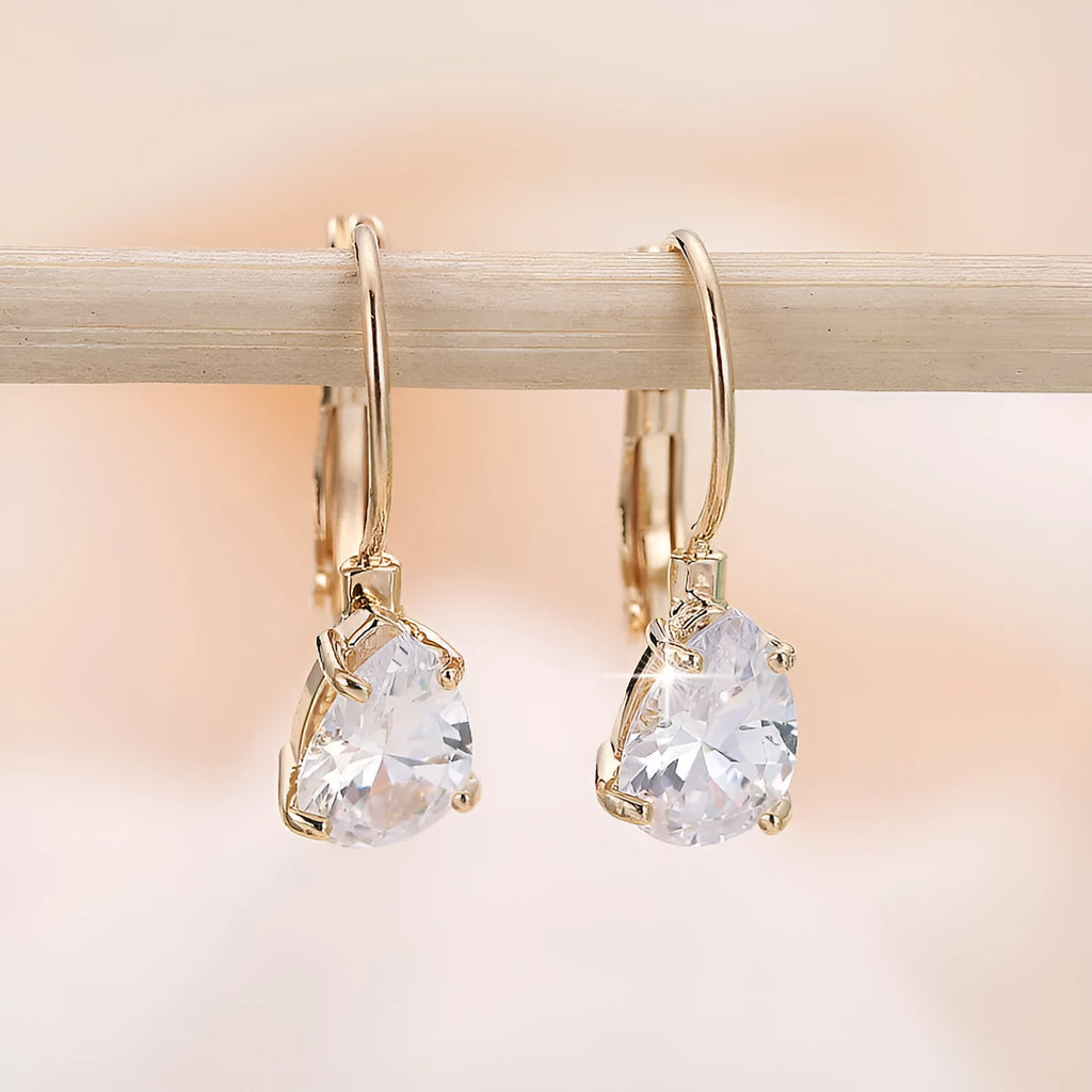 Drop-shaped women's metal earrings with gemstones in gold or platinum colour.