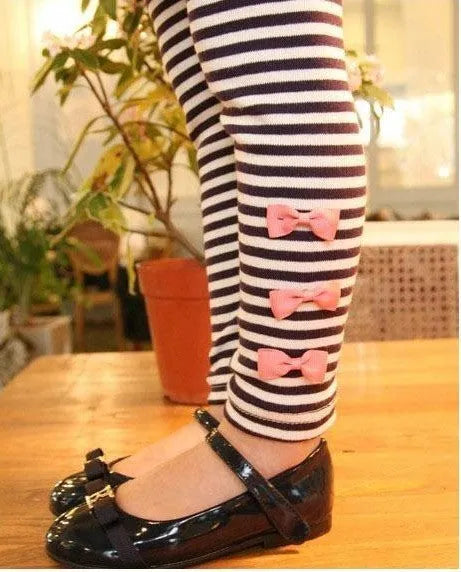 Pink cotton two-piece clothing set for a girl, shown on a hanger.