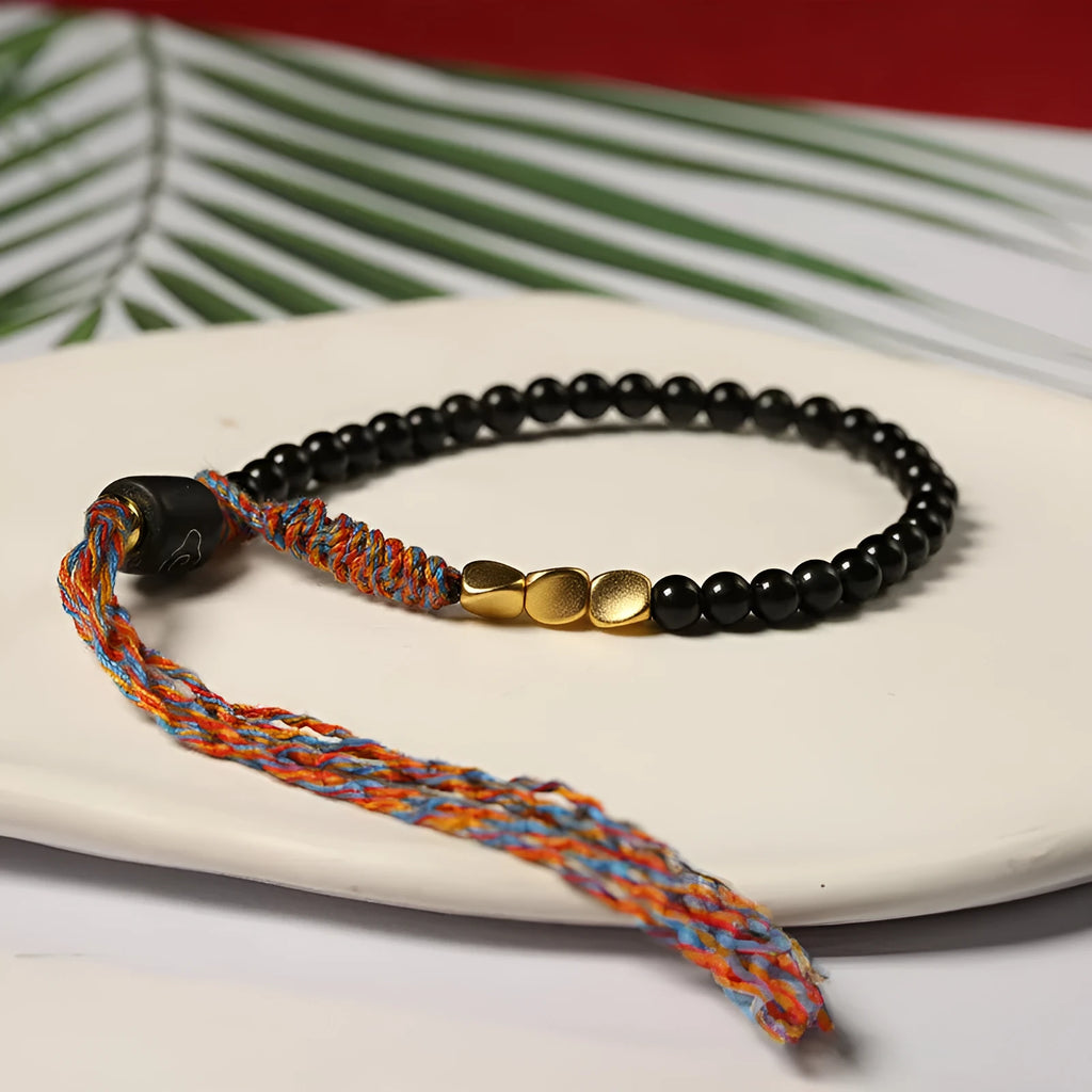 Hand-woven obsidian bead bracelet strap on a wrist, showing its 4mm width and dark colour.
