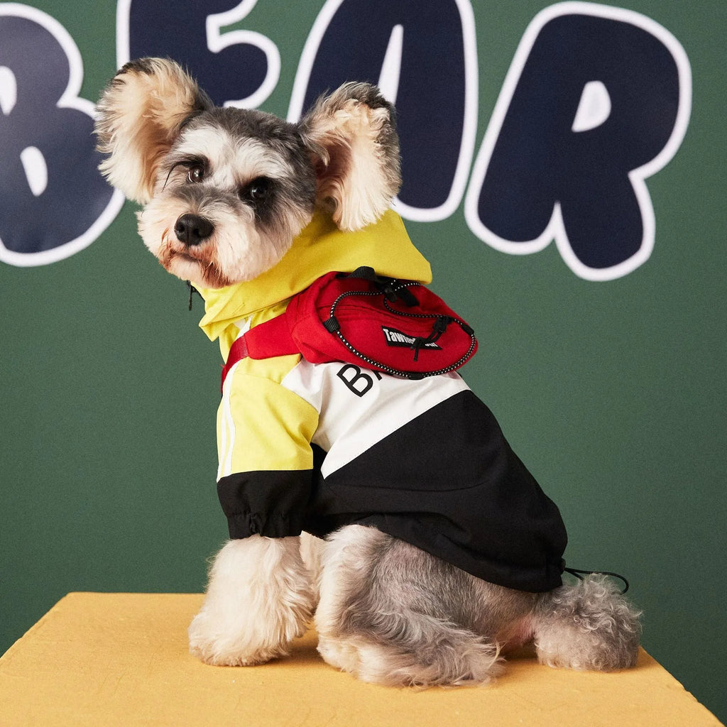 Red waterproof polyester dog raincoat jacket laid flat showing front view with hood