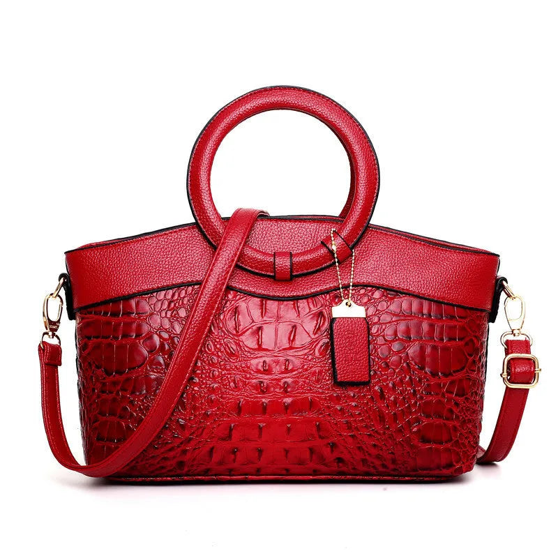 Fabric women's handbag showing multiple zipper compartments and organisational pockets