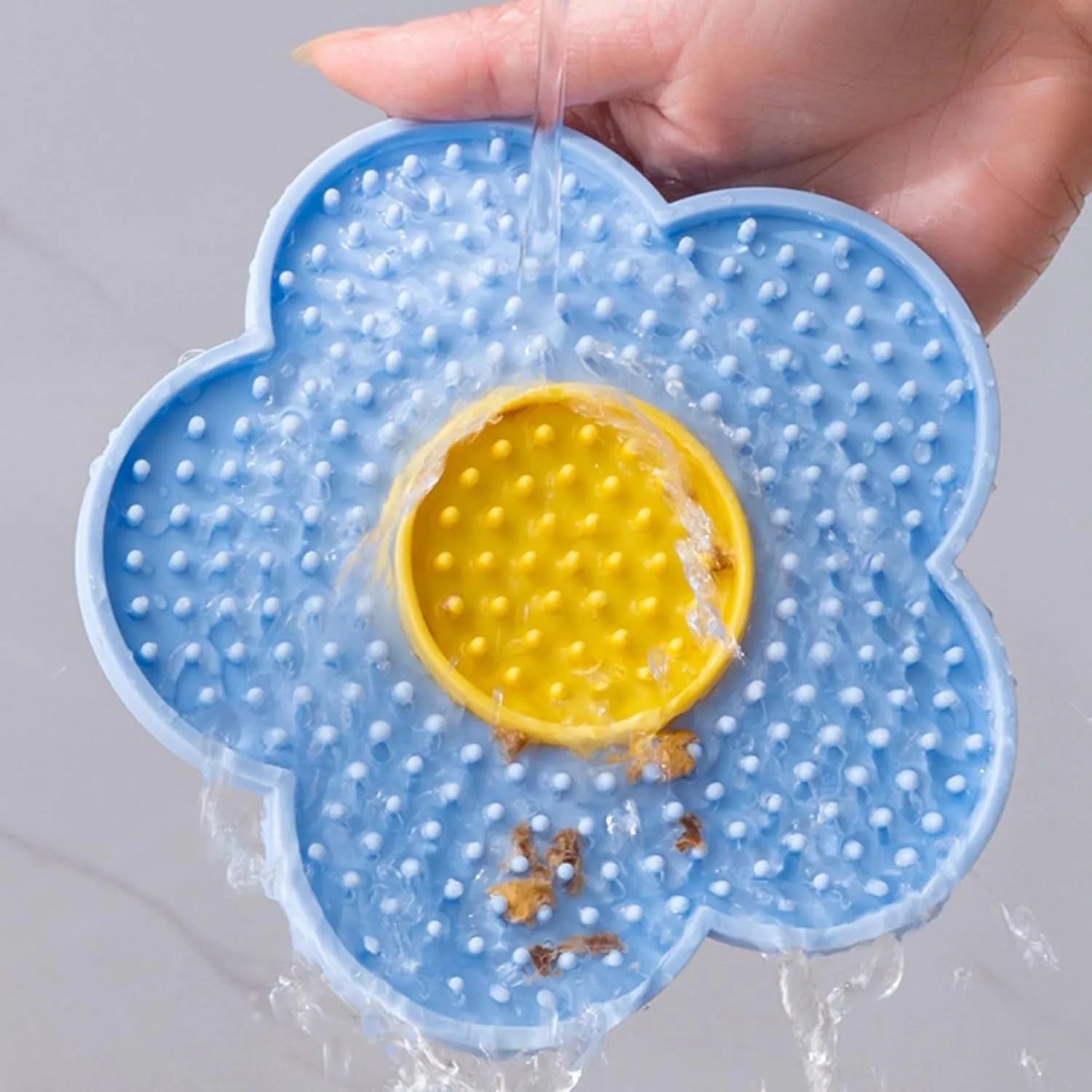 Flower-shaped silicone pet lick pad with suction cup base in assorted colours.