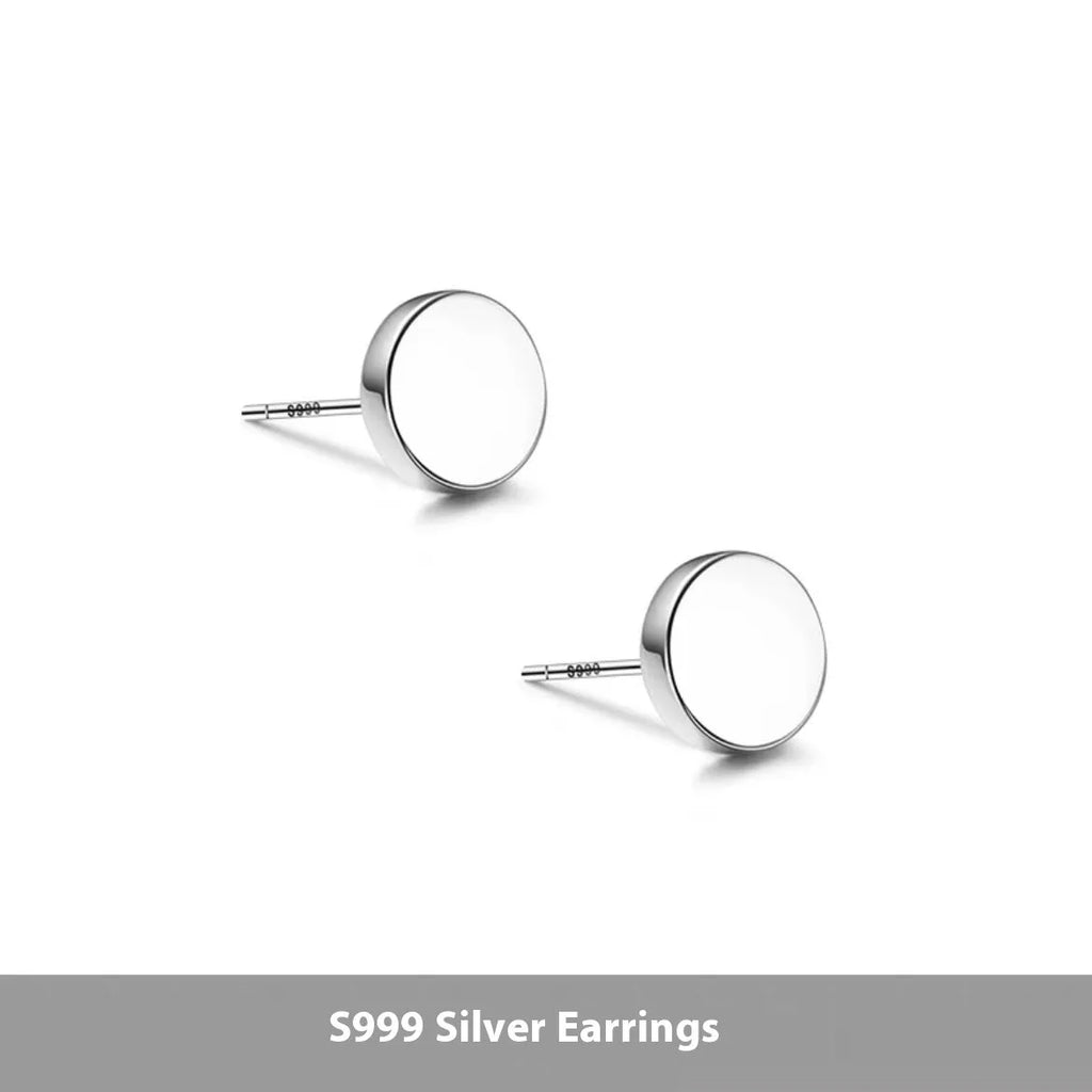 A pair of simple round flat-front sterling silver S999 ear bone stud earrings on a plain background.